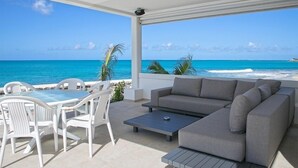 A modern outdoor seating area with a view of the ocean.