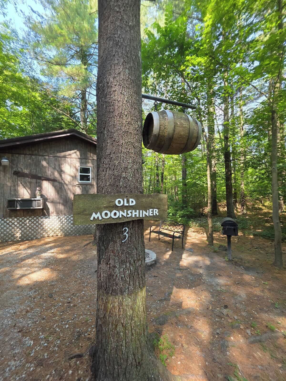 A wooden signpost with 'Old Moonshiner' and a number '3' indicating a location.