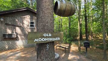 A wooden signpost with 'Old Moonshiner' and a number '3' indicating a location.