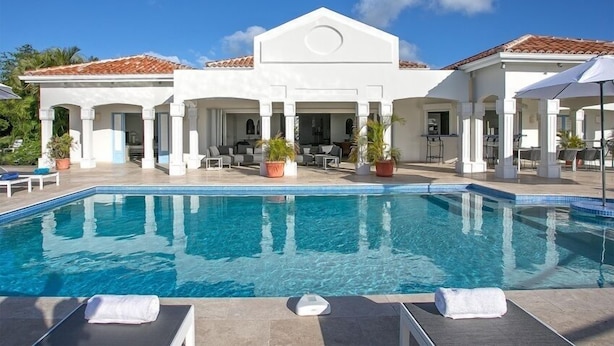 A poolside area with lounge chairs and a clear blue pool. - Villa Oceane  | Ocean View - Located in  Fabulous Terres Basses with Private Pool (Les Terres Basses)