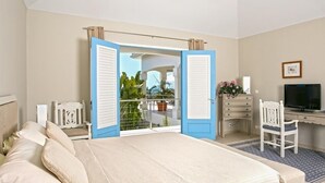A bedroom with a bed, a desk, a chair, and a TV. - Villa Oceane  | Ocean View - Located in  Fabulous Terres Basses with Private Pool (Les Terres Basses)
