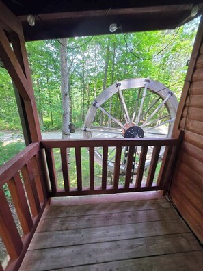 A wooden deck with a large wooden wheel structure in the background.