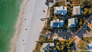 An aerial view of a coastal residential area with houses, a beach, and a parking lot. - Escape to Blue Mountain Beach – GOLF CART, Pool, Gym & Rec Courts (Santa Rosa Beach)