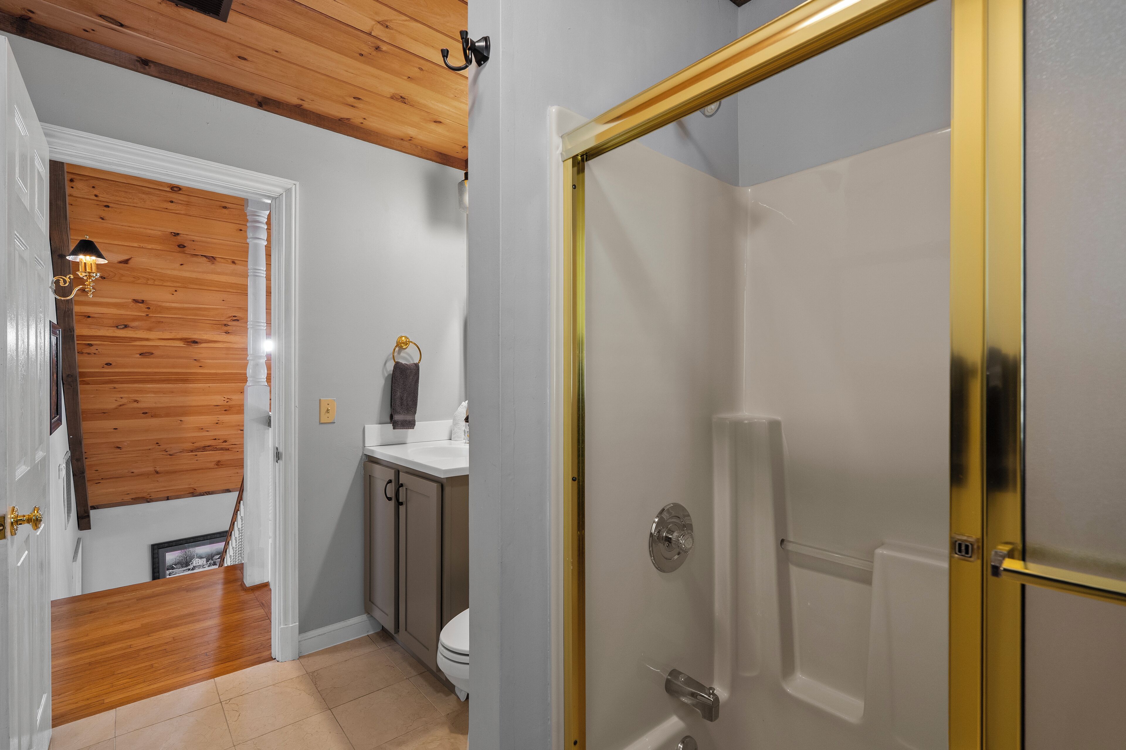 A bathroom with a shower, toilet, and sink.