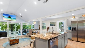 A spacious kitchen with a large island, stainless steel appliances, and a view of the outdoors. - Riverfront Home on the Ohio River, Private Dock, Hot Tub, Sleeps 8 (Prospect)