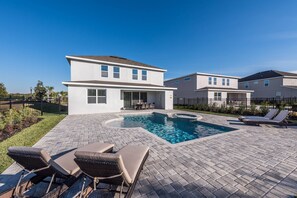 A modern two-story house with a swimming pool and outdoor seating. - Encore Resort 5 Bedroom Home with Pool (2100) (Kissimmee)