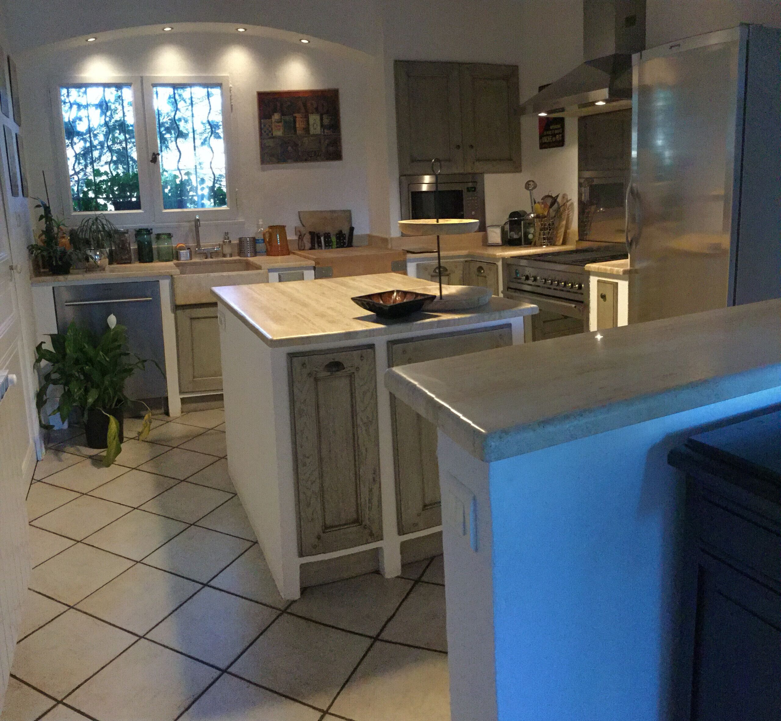 A modern kitchen with a central island, built-in appliances, and ample counter space.