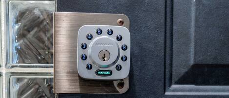 A door with a keypad lock and a door handle.
