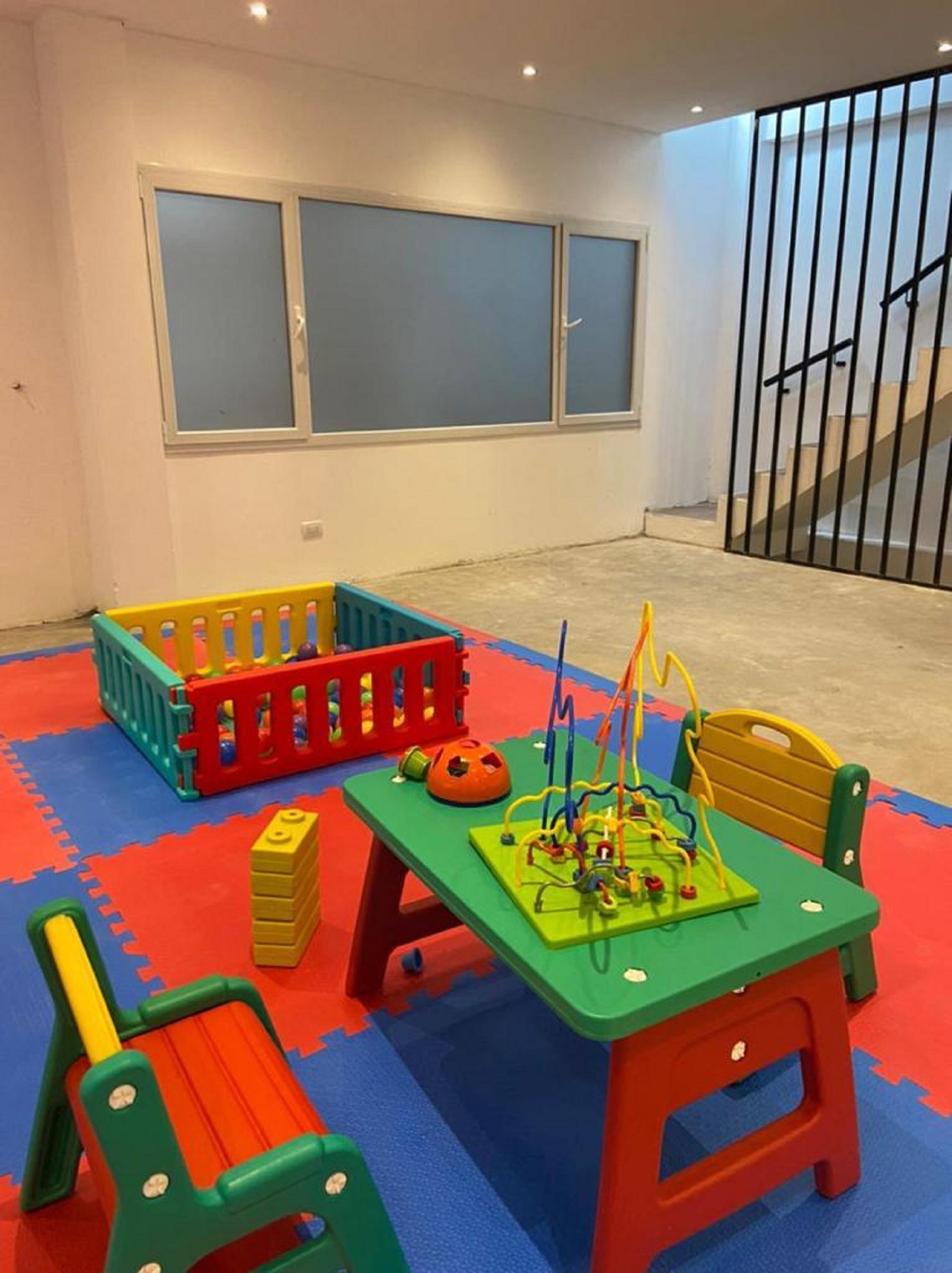 A play area with colorful toys and a green table.