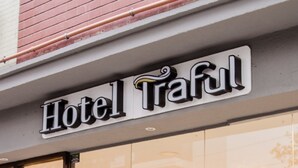 A hotel sign with the name "Hotel Traful" above a glass entrance. - Hotel Traful (Mar del Plata)