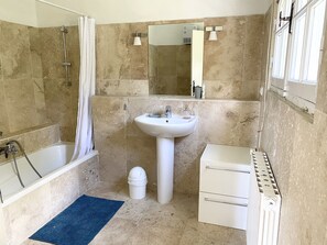 Bathtub, towels, toilet paper