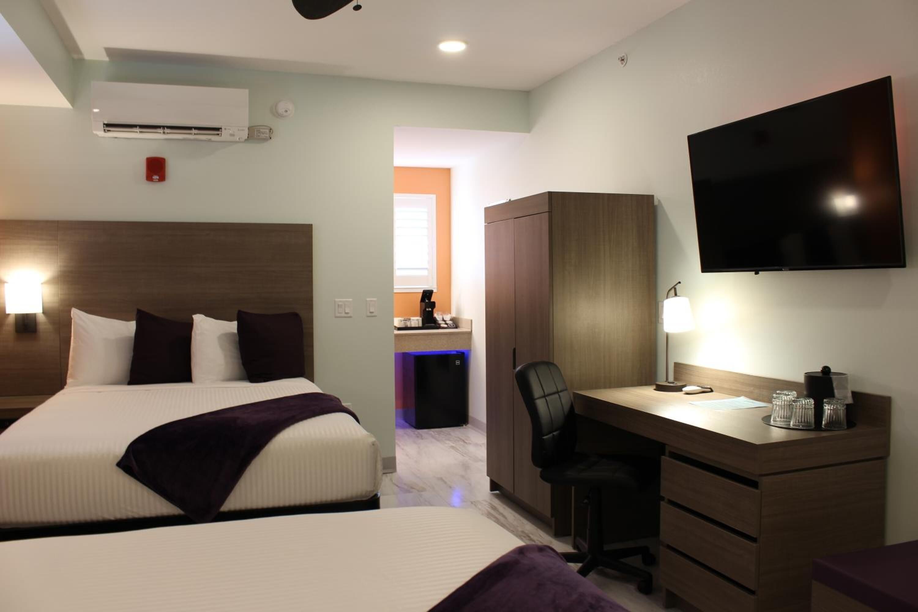 premium bedding, pillow-top beds, desk, laptop workspace