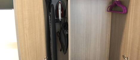 A wooden wardrobe with a hanging rack and a coat rack.