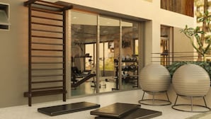 A modern gym with exercise equipment, a wooden bench, and two exercise balls. -  Charlie Vila Nova Conceição Jacques Félix (São Paulo)