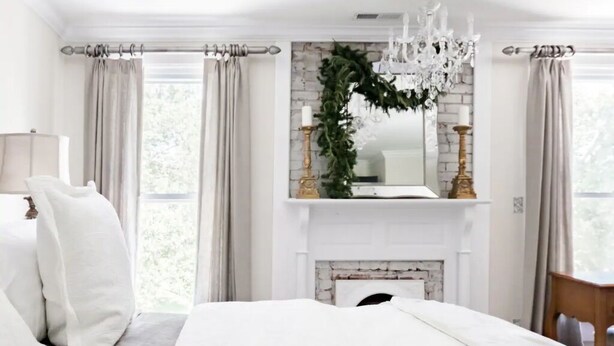 A bedroom with a bed, a fireplace, and curtains. - The Belle at Avery Lafayette Suite (Morganton)