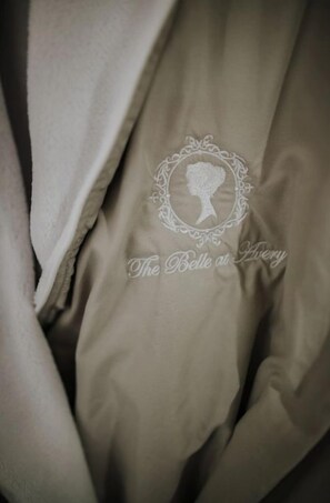 A close-up of a beige fabric with an embroidered monogram and text.