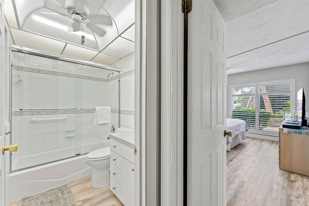 A modern bathroom with a shower, toilet, and vanity.