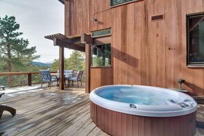 A wooden deck with a hot tub, outdoor furniture, and a pergola. - Chic Boulder Mountain Home w/ Hot Tub + Views (Boulder)