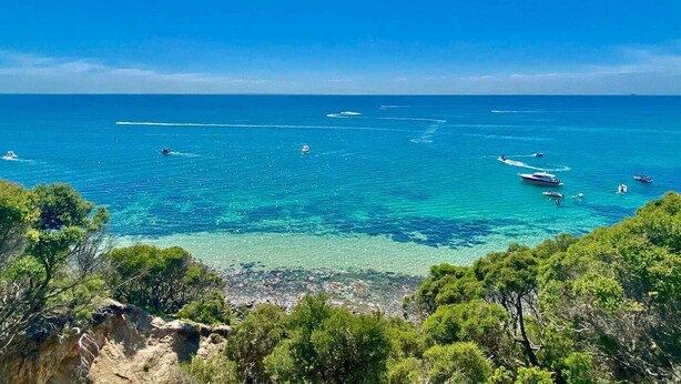 A coastal view with clear turquoise waters, boats, and dense greenery. - Mount Martha Oceanfront Retreat | Pool, Spa, Views | Pet & Family Friendly (Mount Martha)