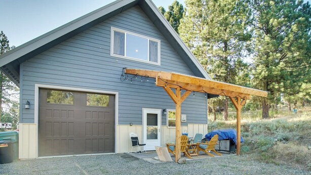 A two-story house with a garage, a covered patio with outdoor furniture, and a gravel driveway. - Cascade Cabin Hideaway w/ Views, 1/2 Mi to Lake (Cascade)