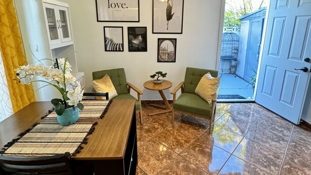 A dining area with a wooden table and chairs, a ceiling fan, and framed pictures on the wall. - Private Studio 4 minutes from Strip !!! (Las Vegas)