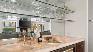 A modern kitchen with a marble countertop, wine glasses, a bottle of wine, and a cheese board. - Everything you want! Pool/spa, Golf Course, Mountain Views (Palm Desert)