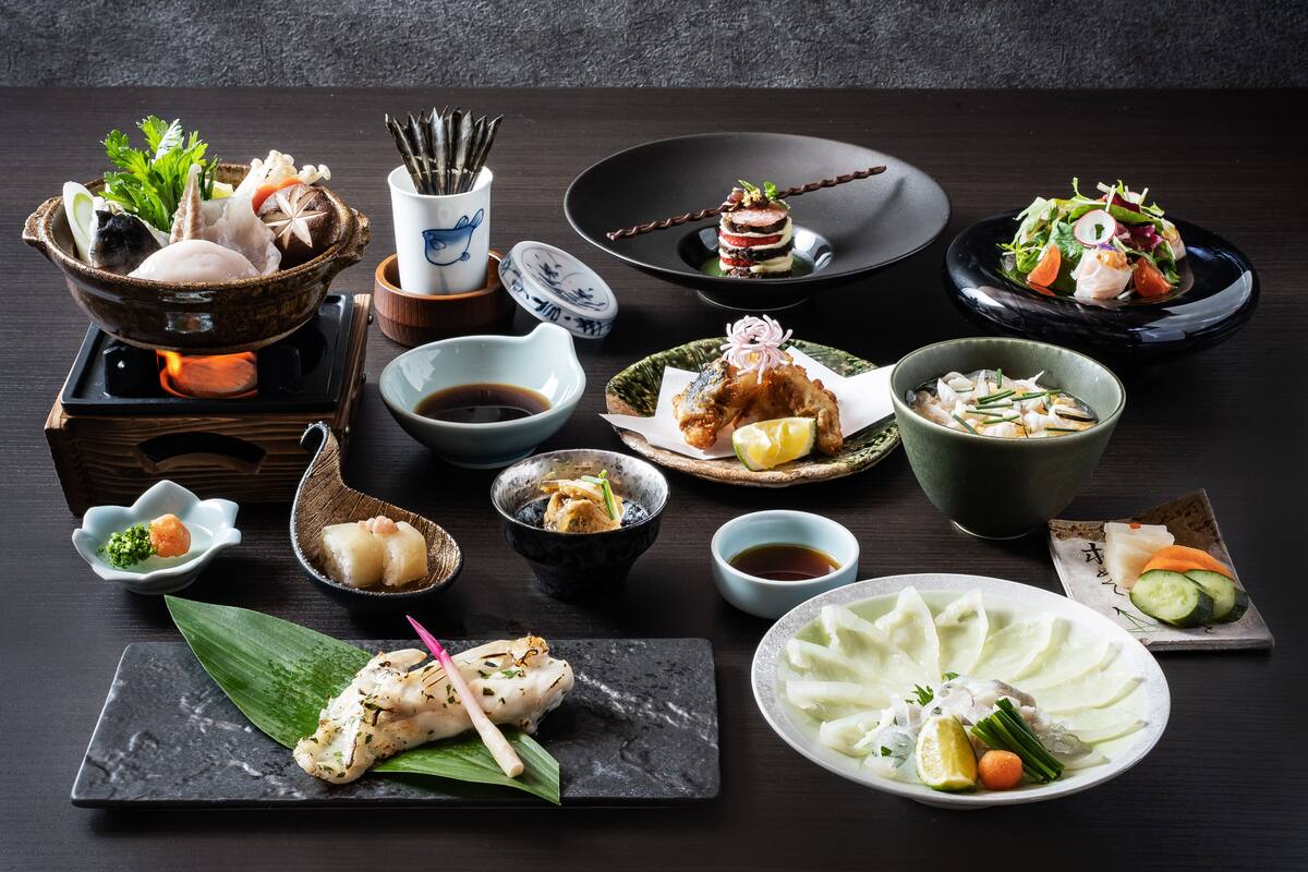 A variety of Japanese dishes arranged on a dark table.