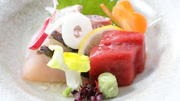 A dish with various ingredients including radish, lemon, and possibly some type of meat or fish.