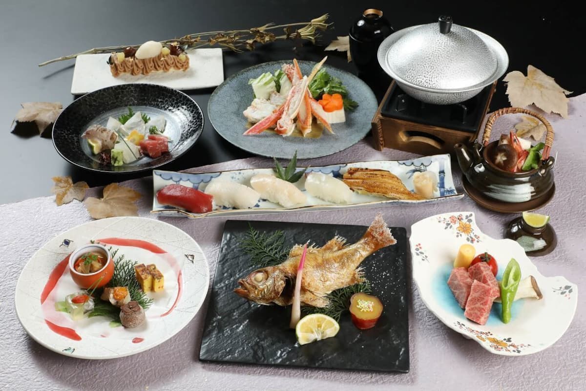 A variety of dishes on a table, including seafood, vegetables, and a fish.