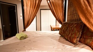 A neatly made bed with a floral-patterned bedspread and a rolled-up towel on the left side. - 🔳 48% discount • Steam Shower • 9 mins @ Airport  (Richmond)