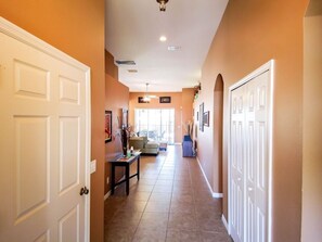 Stylish hallway with a seating area and doors leading to various rooms.