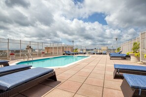 Relax by the pool surrounded by lush greenery and take in the breathtaking views of the sky.