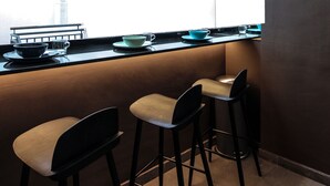 A kitchen area with a window, a sink, and two bar stools. - ST Signature Bugis Beach, DAYUSE, 8-9 hours: check in 8AM or 11AM (Singapore)