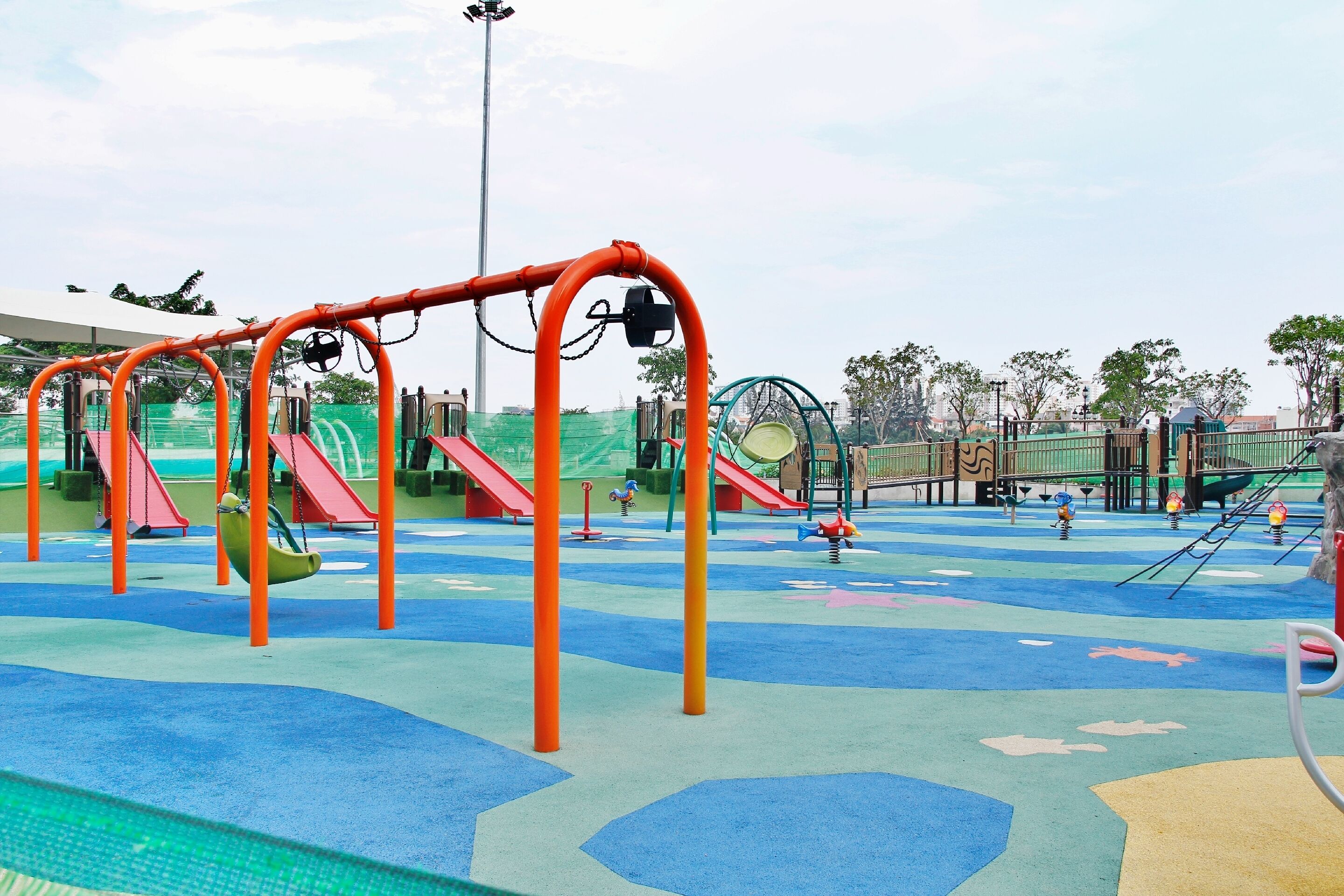 A playground with swings, slides, and climbing structures.