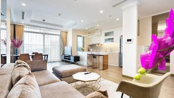 Relax in this inviting living space with a comfortable sofa, coffee table, and armchair, perfect for unwinding.