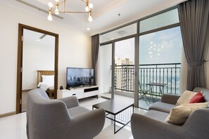 Deluxe Apartment, 3 Bedrooms, Balcony, City View (Sens House) | Living area | 49-inch Smart TV with digital channels, TV - Sens House Saigon – Serviced Apartments in Vinhomes Central Park (Ho Chi Minh City)