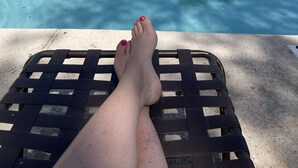 A pool area with a clear blue pool, lounge chairs, and a building with a tiled roof in the background. - Beautiful centrally located townhome in The Gardens, Gilbert (Gilbert)