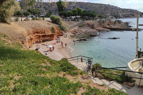 Guests can enjoy stunning ocean views from the beach, with access to the water via a staircase.