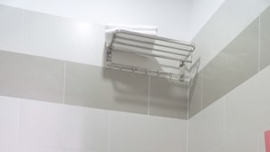 A bathroom with a white toilet, a towel rack, and a sink. - Dai An Binh Tan Hotel (Ho Chi Minh City)