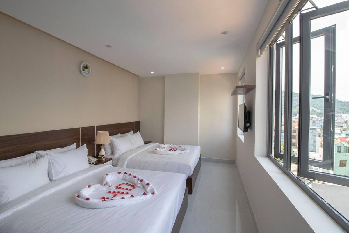 Deluxe Quadruple Room, Balcony | Minibar, desk, free WiFi, bed sheets