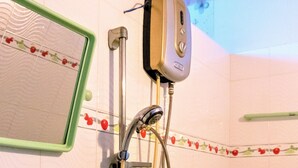 A bathroom with a shower, a handheld showerhead, and a wall-mounted control panel. - Khanh Vy Hotel Binh Tan (Ho Chi Minh City)