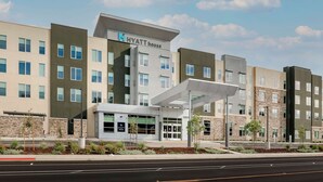 A multi-story hotel with a modern design, featuring a prominent entrance with a canopy and a sign that reads "HYATT House". - Hyatt House Davis (Davis)
