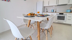 A modern kitchen with white cabinets, a white refrigerator, and a blue toaster. - Holiday Home Rosemary (Slivno)