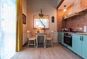 Enjoy meals in this cozy kitchen with an oven, range hood, and dining area.