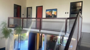 A multi-level interior with a staircase connecting floors, a kitchen area, and a dining space. - Beach House in Porto Seguro (Coroa Vermelha) 30 meters from the beach.  (BA)
