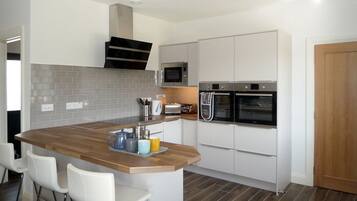 Microwave, dishwasher, high chair, cookware/dishes/utensils