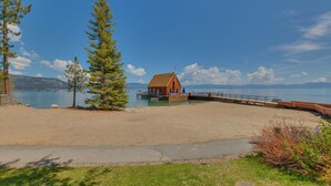 A beach with a wooden structure, a pier, and a clear sky. - Chamberlands Cabin: 5  BR, 3  BA House in Tahoma, Sleeps 10 (Tahoma)