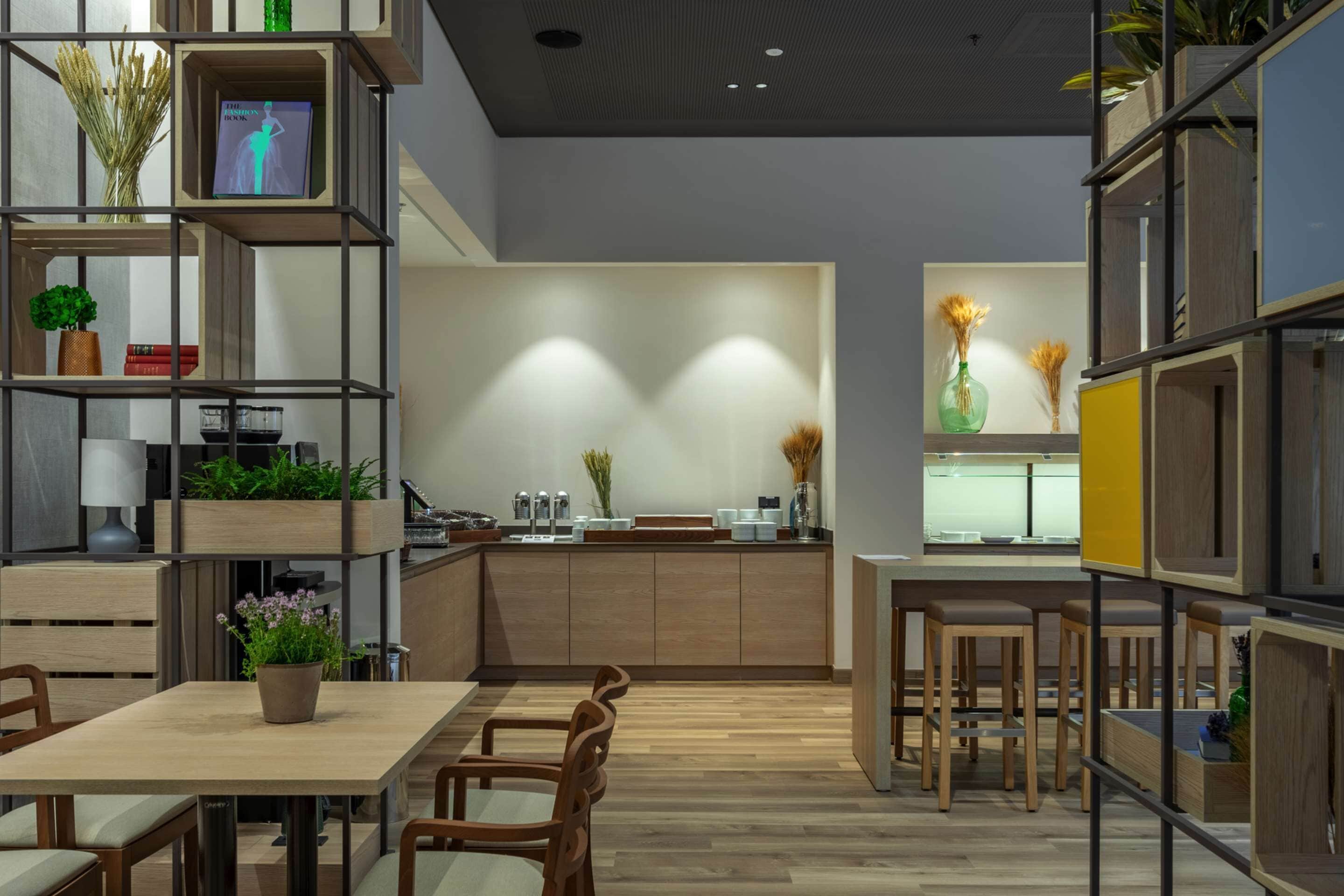 A modern kitchen with wooden cabinets, a central island, and built-in seating.