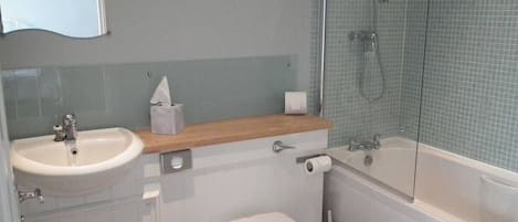 A bathroom with a sink, toilet, and bathtub.