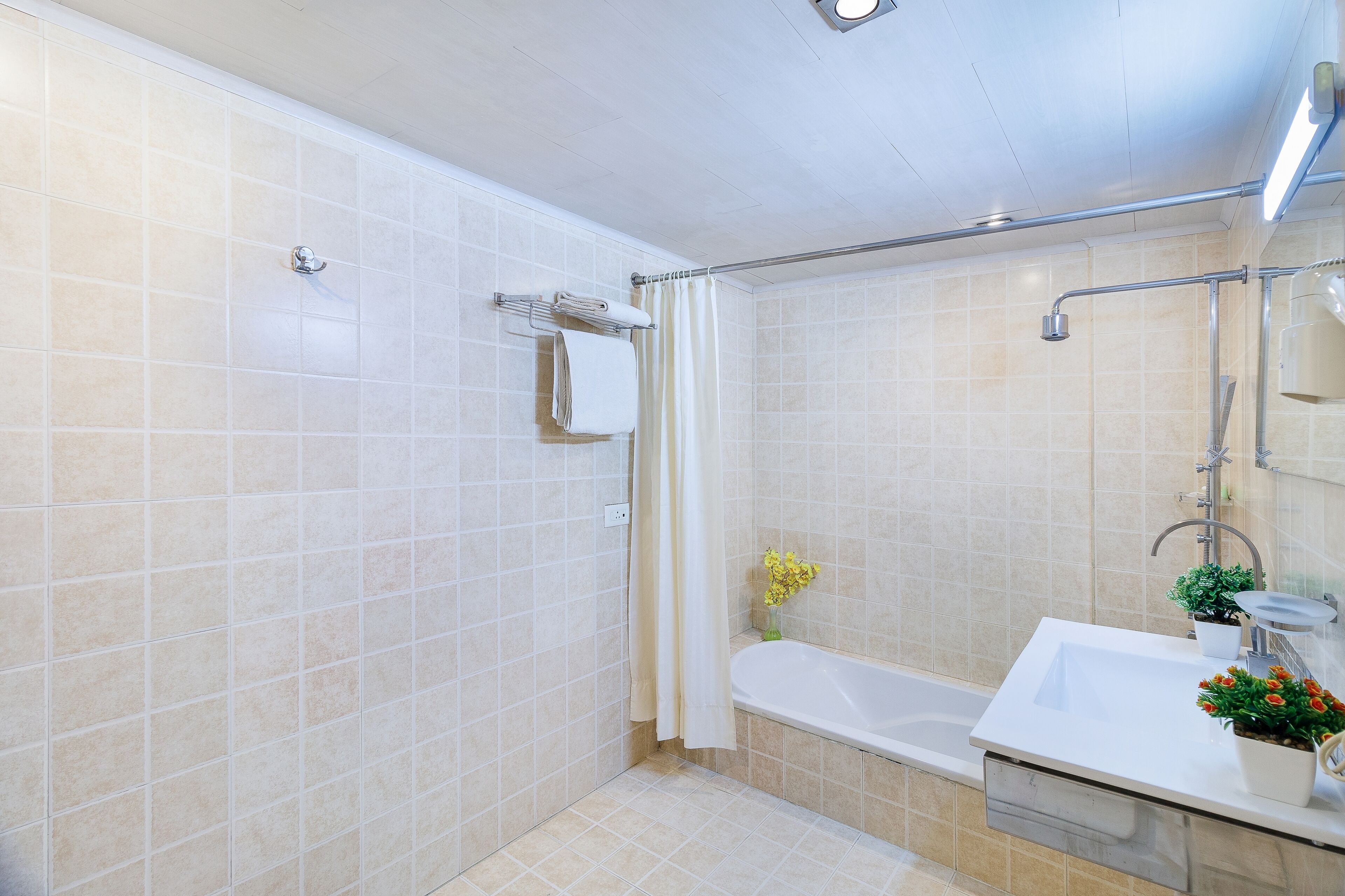 A modern bathroom with a shower, a bathtub, and a sink.